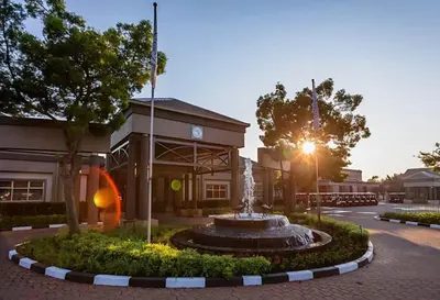 a fountain in front of a building at Pine & Pebble in Centurion
