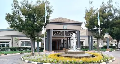 a building with a fountain in front of a building at Pine & Pebble in Centurion