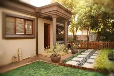 a house with three potted plants in the front yard at Pine & Pebble in Centurion