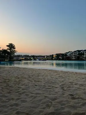 a view of a beach with buildings in the background at 2 Bedroom The Blyde Crystal Lagoon Luxe in Pretoria