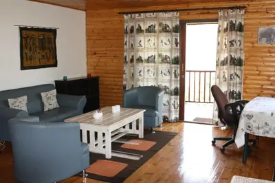 a living room with a table and chairs at Lerato Bush Lodge in Pretoria