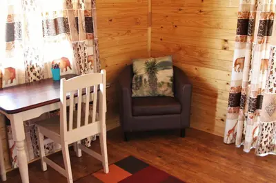 a room with a table and a chair and a desk at Lerato Bush Lodge in Pretoria