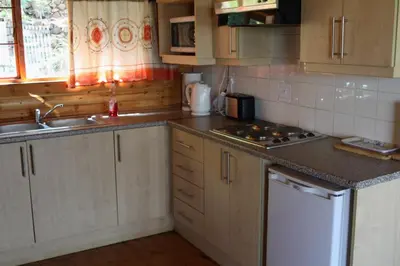 a kitchen with a sink and a counter top at Lerato Bush Lodge in Pretoria
