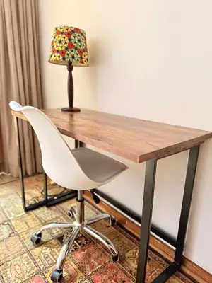 a desk with a white chair and a lamp at Cosy flat with garden near Loftus & embassies in Pretoria