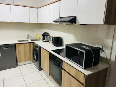 a kitchen with a microwave and a stove top oven at The Blyde Lagoon apartment in Pretoria