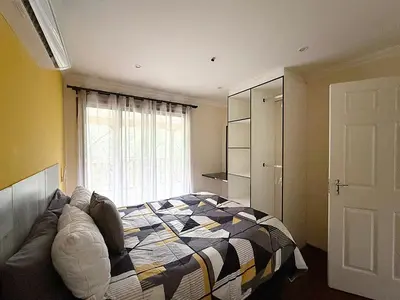 a bedroom with a bed in front of a window at Vulture Suite Hippo Waterfront Lodge in Nelspruit