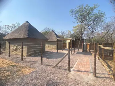 a playground with a building with a roof at Vlakvark Tented Camp in Bela-Bela