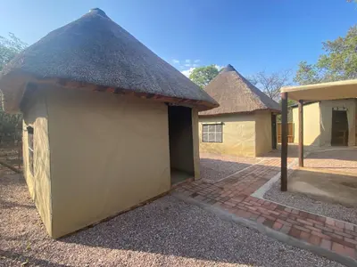 a small building with a thatched roof at Vlakvark Tented Camp in Bela-Bela