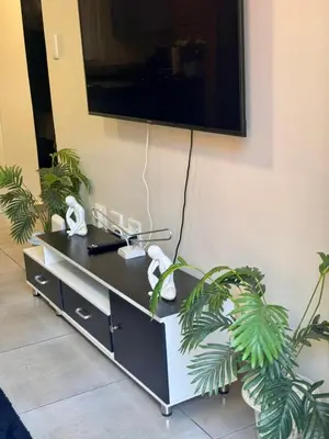 a flat screen tv hanging on a wall at Waterfall Garden Unit in Midrand
