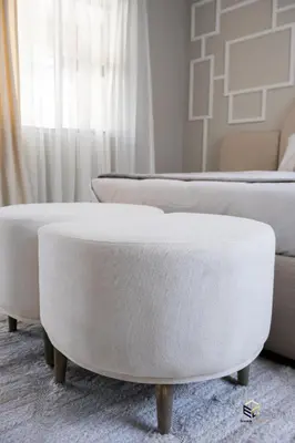 a white ottoman in a living room with a couch at Ezomdabu Guesthouse in Pretoria