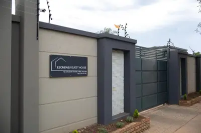 a garage with a sign on the side of a house at Ezomdabu Guesthouse in Pretoria