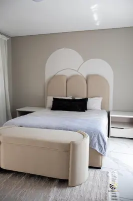 a bedroom with a large bed with a large headboard at Ezomdabu Guesthouse in Pretoria
