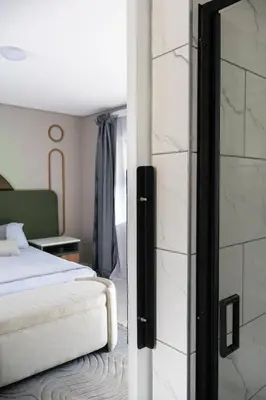 a bedroom with a bed and a glass door at Ezomdabu Guesthouse in Pretoria
