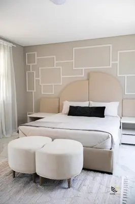 a bedroom with a large bed and two ottoman at Ezomdabu Guesthouse in Pretoria