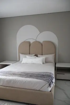 a bedroom with a large bed with a large headboard at Ezomdabu Guesthouse in Pretoria