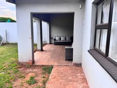 a patio with a couch in the back of a house at Bouleigh in Kempton Park