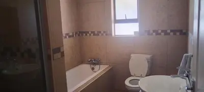 a bathroom with a toilet and a sink and a tub at Bouleigh in Kempton Park