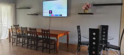 a conference room with a table and chairs and a screen at Bouleigh in Kempton Park