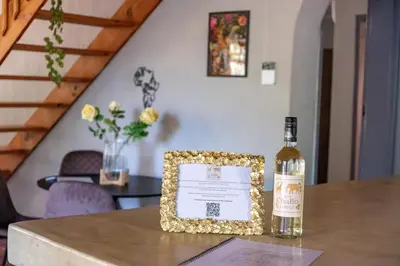 a bottle of wine sitting on top of a table at The ChaBo Lodge in Marloth Park
