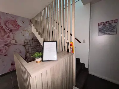 a staircase in a building with a sign on it at Hippo Zwartkop Suites in Centurion