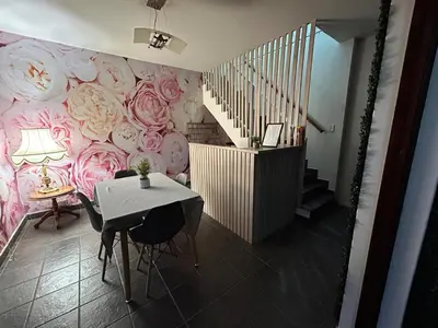 a dining room with a pink floral wall at Hippo Zwartkop Suites in Centurion