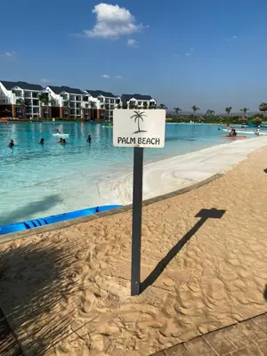 a sign on a beach with people in the water at The Blyde Taffys Place in Pretoria