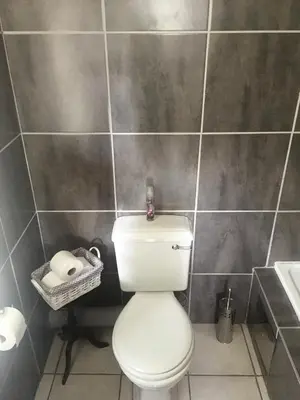 a bathroom with a white toilet and a sink at The Willow Studio in Pretoria