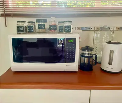 a microwave sitting on top of a kitchen counter at The Willow Studio in Pretoria