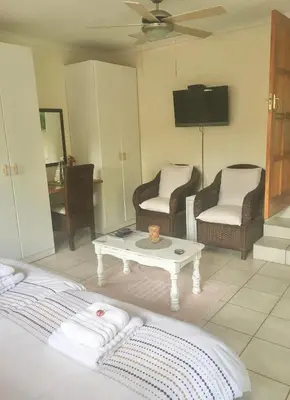 a living room with a couch and a coffee table at The Willow Studio in Pretoria