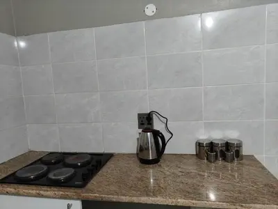 a kitchen counter with a coffee pot on a stove at Tranquil Accommodation in Midrand