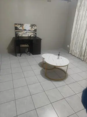 a room with a tub and a chair and a piano at Tranquil Accommodation in Midrand