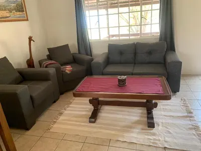 a living room with two couches and a coffee table at Green Door Cottage