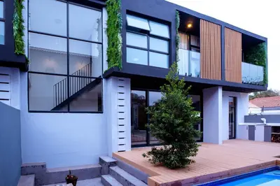 a house with a deck and a swimming pool at The Pinnacle Polokwane in Polokwane