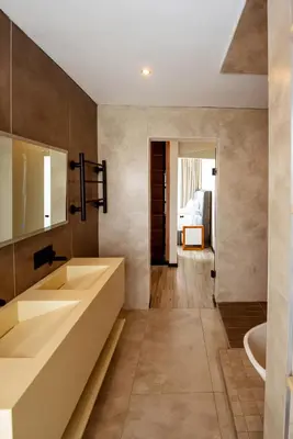 a bathroom with two sinks and a tub at The Pinnacle Polokwane in Polokwane