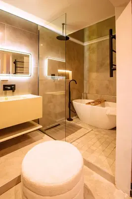 a bathroom with a tub and a toilet and a sink at The Pinnacle Polokwane in Polokwane