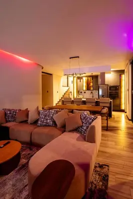 a living room with two couches and a dining room at The Pinnacle Polokwane in Polokwane