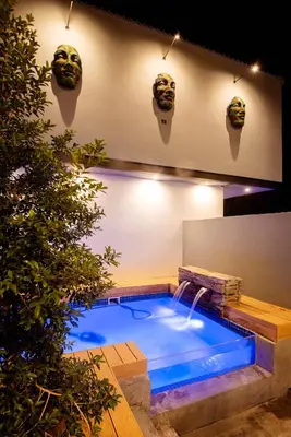 a swimming pool with two masks on the wall at The Pinnacle Polokwane in Polokwane
