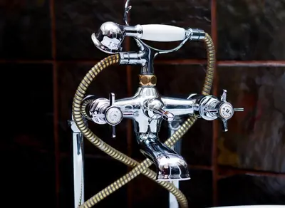 a bathroomaucet with a hose attached to it at GBL Reine Chateau in Polokwane
