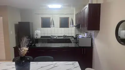 a kitchen with a sink and a counter top at GBL Reine Chateau in Polokwane