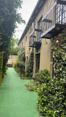 a house with a walkway next to a building at GBL Reine Chateau in Polokwane
