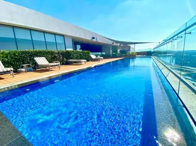 a swimming pool on top of a building at Chic Deluxe Studio, Menlyn Maine, Smart Access in Pretoria