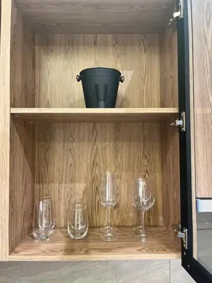 a cabinet with wine glasses and a bucket on it at Chic Deluxe Studio, Menlyn Maine, Smart Access in Pretoria