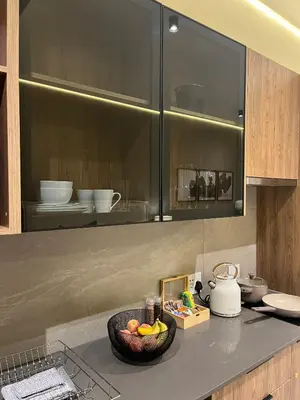 a kitchen with a bowl of fruit on a counter at Chic Deluxe Studio, Menlyn Maine, Smart Access in Pretoria