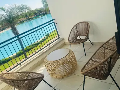 three chairs and a table in front of a window at The Blyde Pretoria in Pretoria