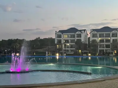 a fountain in a pool in front of some apartments at The Blyde Pretoria in Pretoria