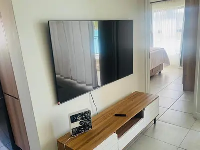 a living room with a television on a wall at The Blyde Pretoria in Pretoria