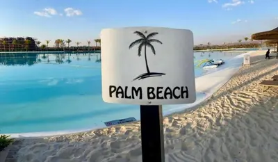 a sign that says palm beach with a palm tree at The Blyde Crystal Logon in Pretoria