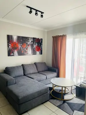 a living room with a couch and a table at The Blyde Crystal Logon in Pretoria