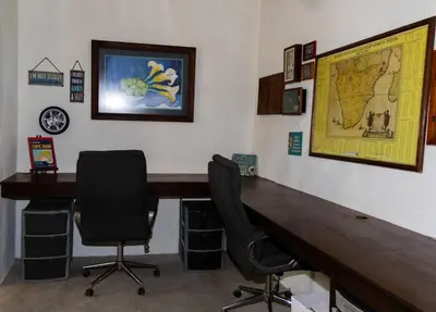 a office with a desk and two chairs and a map at Ses'fikile