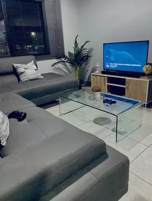 a living room with a couch and a flat screen tv at Wotela in Chartwell